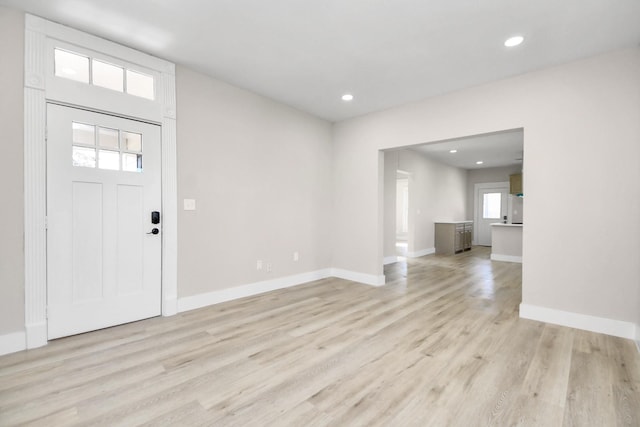 foyer entrance featuring light hardwood / wood-style flooring and a wealth of natural light