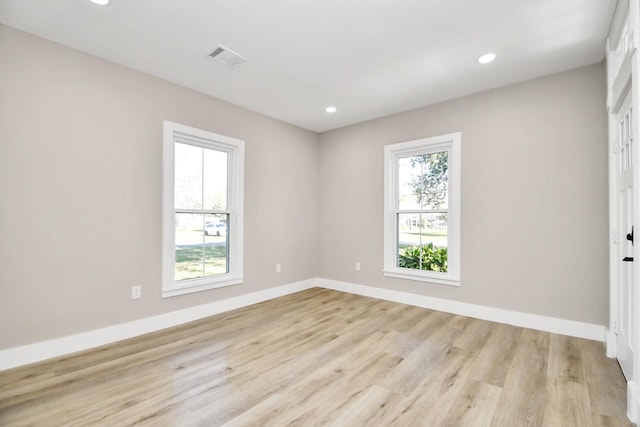 unfurnished room with light hardwood / wood-style flooring