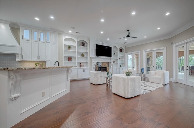 living room with ceiling fan, french doors, crown molding, and dark hardwood / wood-style floors