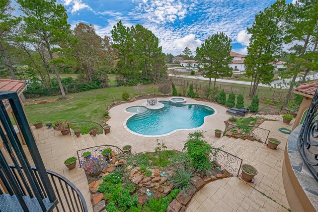 view of swimming pool featuring a patio area, a lawn, and an in ground hot tub