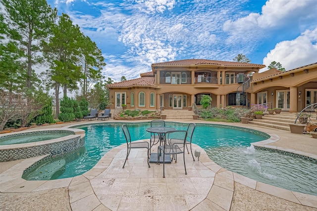 view of pool featuring a patio, french doors, and a pool with connected hot tub