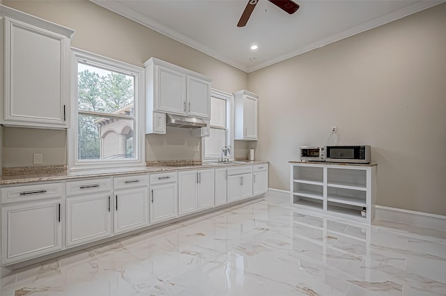 kitchen featuring stainless steel microwave, marble finish floor, ceiling fan, and white cabinets