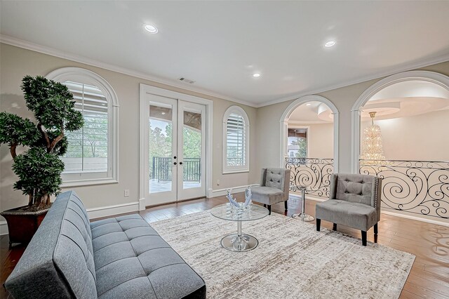 living room featuring ornamental molding, french doors, and wood-type flooring