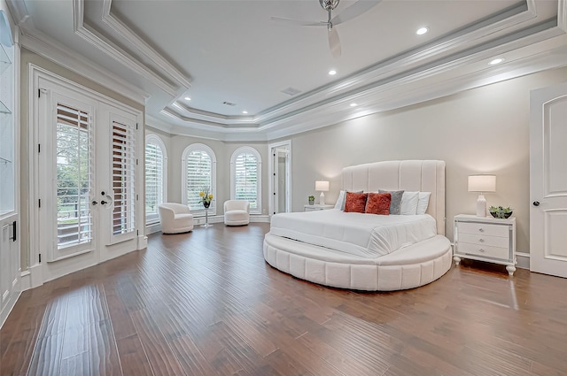 bedroom featuring wood finished floors, recessed lighting, crown molding, a raised ceiling, and access to exterior