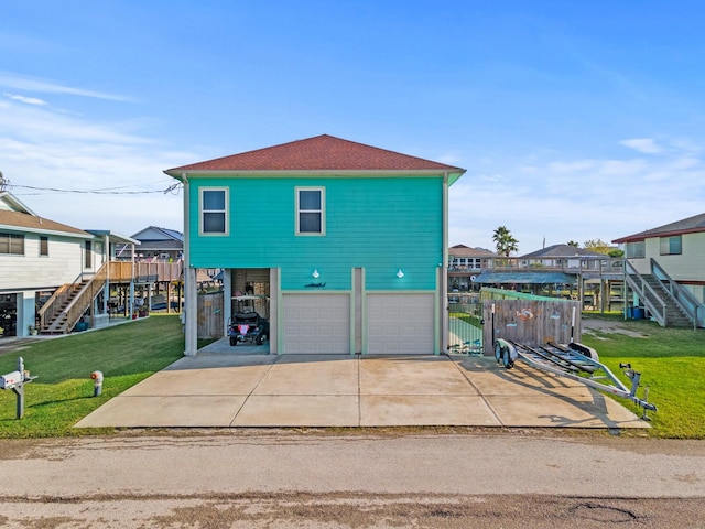 view of front of property with a front yard and a garage