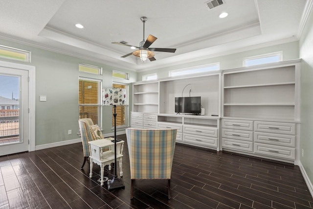 dining area with a tray ceiling, ceiling fan, and ornamental molding