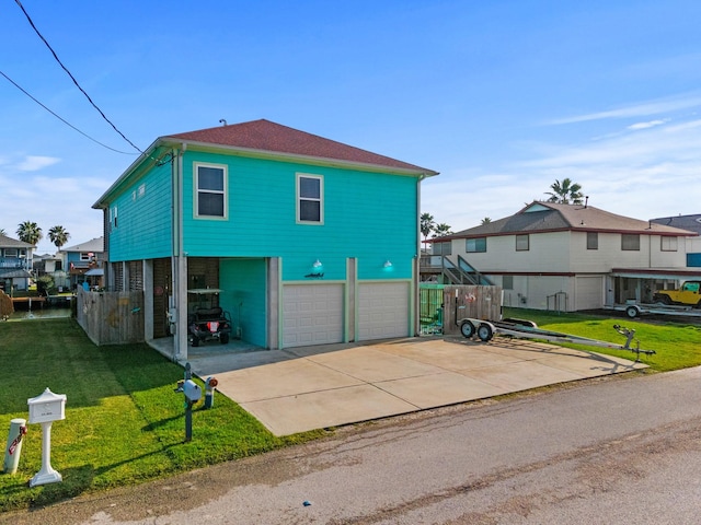 view of front of property with a front yard and a garage