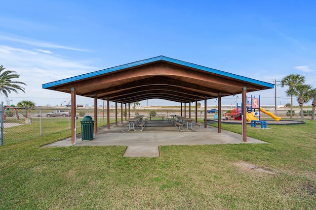 view of property's community featuring a lawn and a playground