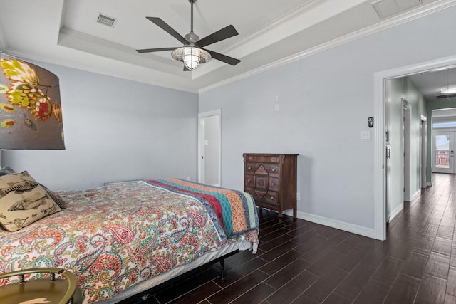 bedroom with ceiling fan, a raised ceiling, and crown molding