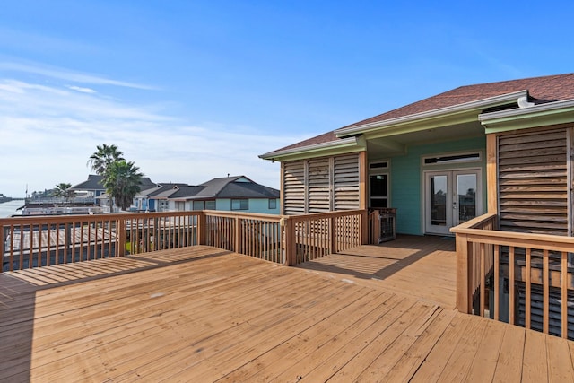 wooden deck with french doors and a water view