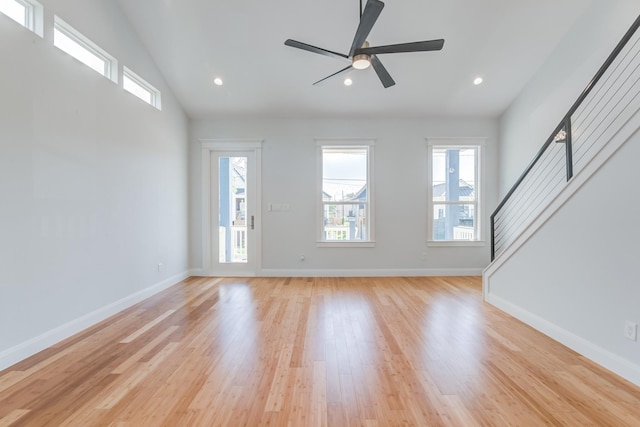 unfurnished living room featuring ceiling fan, light hardwood / wood-style floors, and lofted ceiling