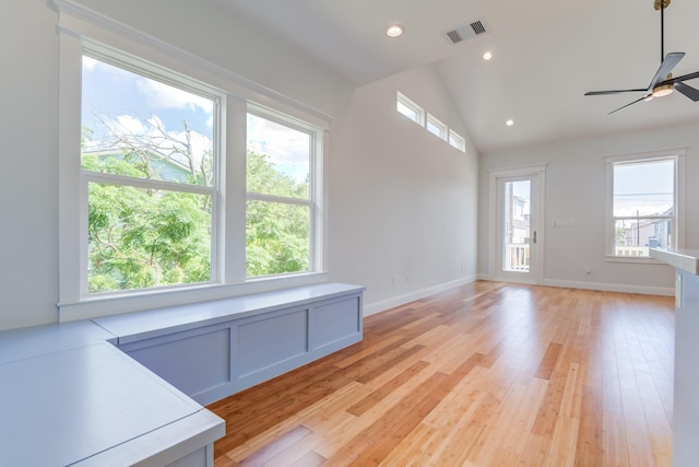 unfurnished living room with light hardwood / wood-style floors, ceiling fan, and lofted ceiling