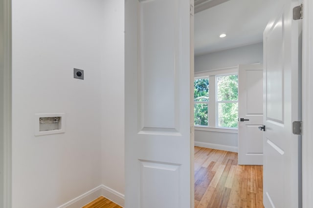 washroom featuring electric dryer hookup, light hardwood / wood-style floors, and washer hookup