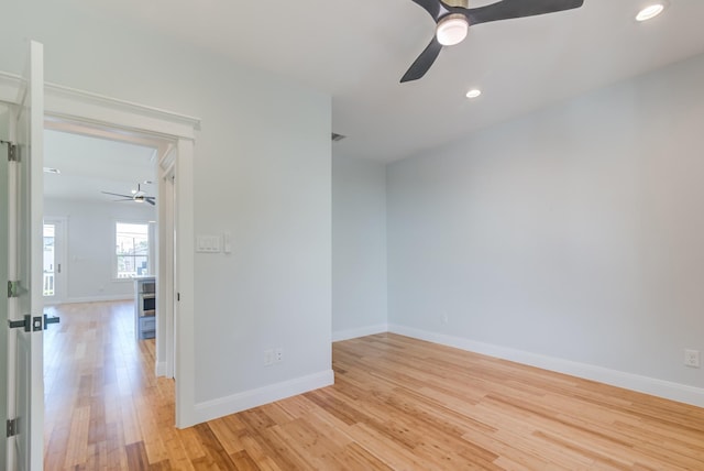 spare room featuring light wood-type flooring and ceiling fan