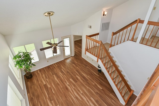 stairs featuring hardwood / wood-style flooring, ceiling fan, and lofted ceiling