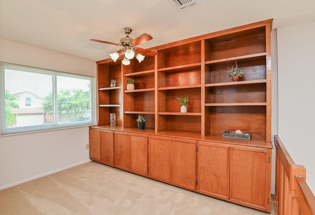 unfurnished office with light colored carpet and ceiling fan