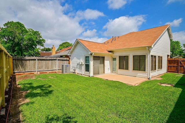 back of property with a patio area, a yard, and cooling unit