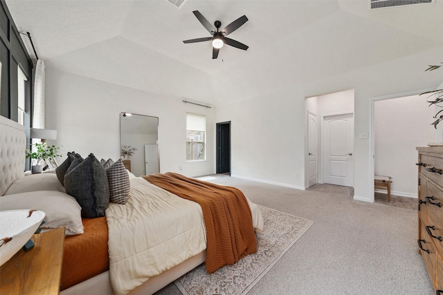 bedroom featuring light carpet, a tray ceiling, ceiling fan, and lofted ceiling