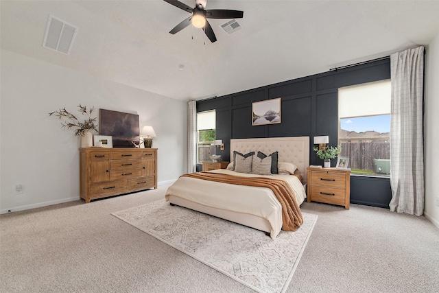 carpeted bedroom with multiple windows and ceiling fan