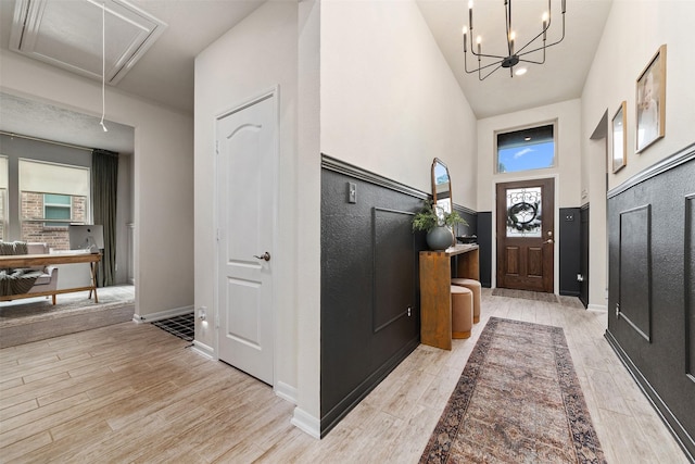 entryway with a towering ceiling and a chandelier