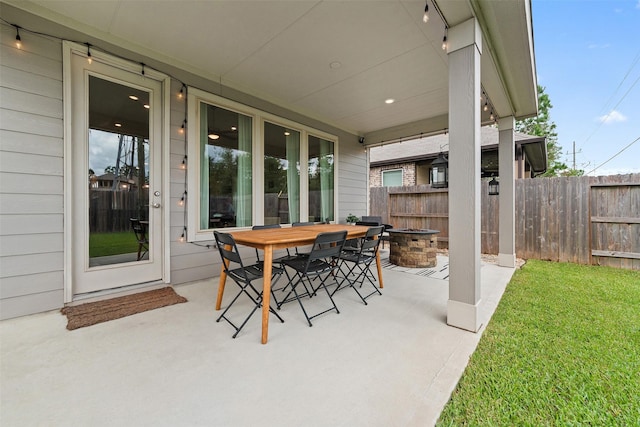 view of patio with a fire pit