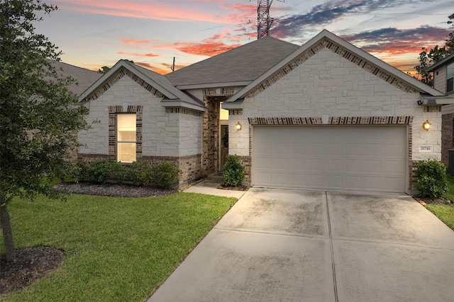 view of front of house with a garage and a yard