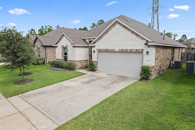 view of front facade with cooling unit, a garage, and a front yard