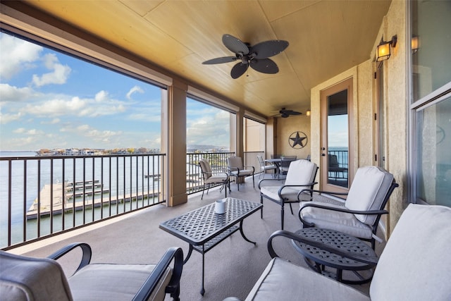 exterior space featuring ceiling fan, a water view, and wooden ceiling