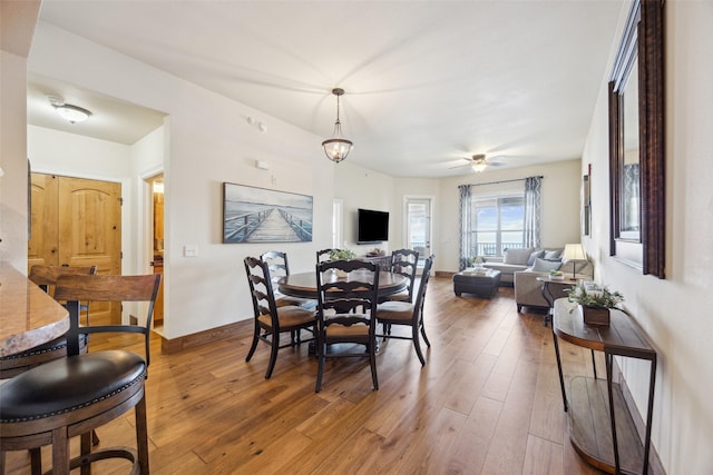 dining room with hardwood / wood-style flooring and ceiling fan