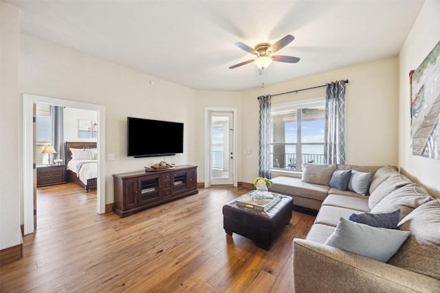 living room featuring ceiling fan and hardwood / wood-style floors