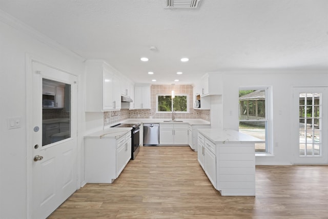 kitchen with white cabinets, crown molding, and appliances with stainless steel finishes