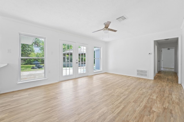 unfurnished living room featuring french doors, light wood-type flooring, ceiling fan, and crown molding