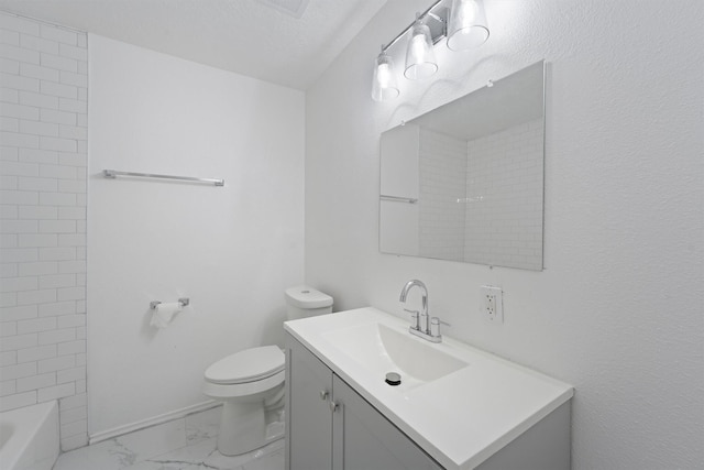 bathroom with vanity, toilet, and a textured ceiling