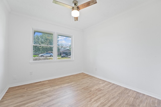 spare room featuring crown molding, ceiling fan, and light wood-type flooring