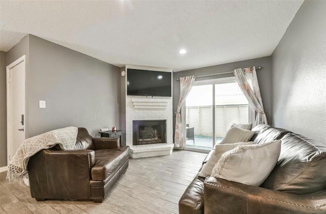 living room featuring a fireplace and a textured ceiling