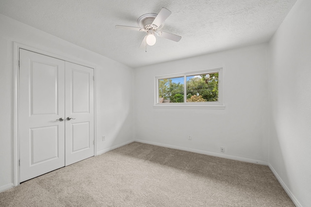 unfurnished bedroom with carpet floors, a closet, and ceiling fan