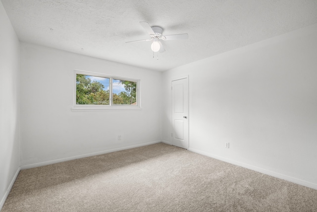 spare room featuring carpet and ceiling fan