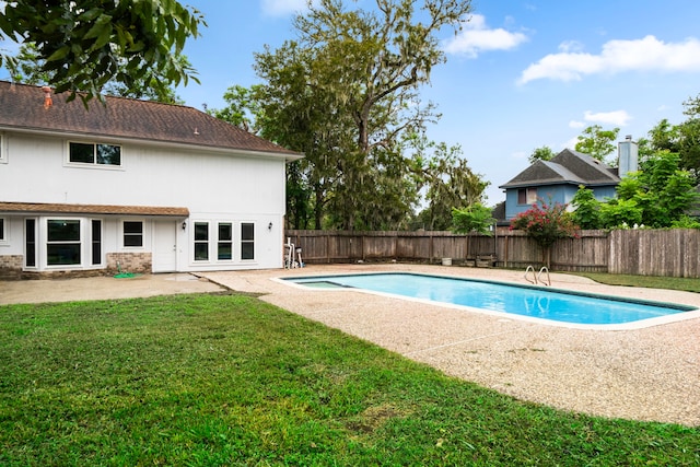 view of swimming pool featuring a yard and a patio