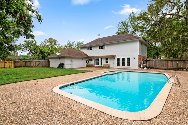 view of swimming pool featuring a yard and a patio