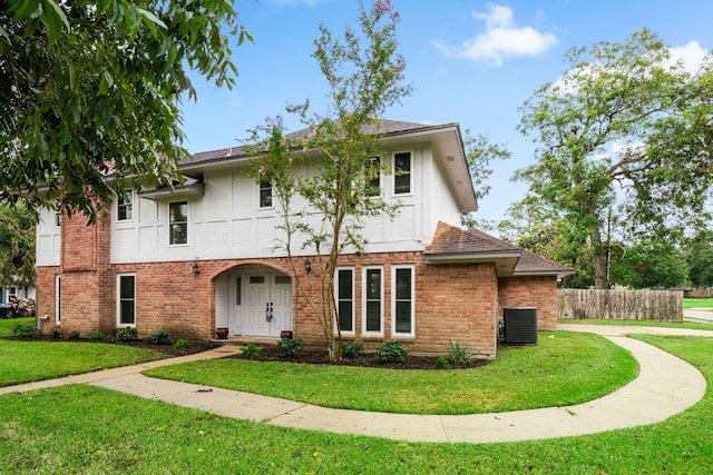 view of front of home featuring a front yard and central air condition unit