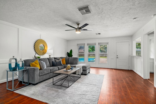 living room with dark hardwood / wood-style floors and ceiling fan