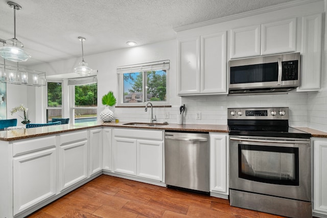 kitchen featuring sink, white cabinetry, and stainless steel appliances