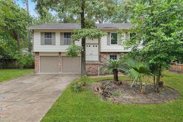 raised ranch featuring a front lawn and a garage