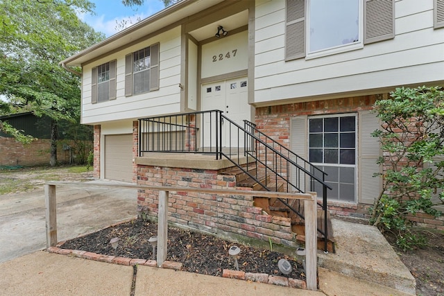 view of exterior entry with a garage