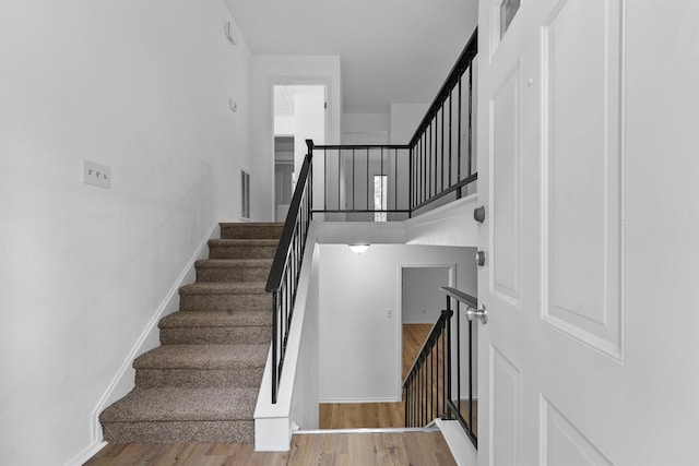 stairway featuring hardwood / wood-style floors