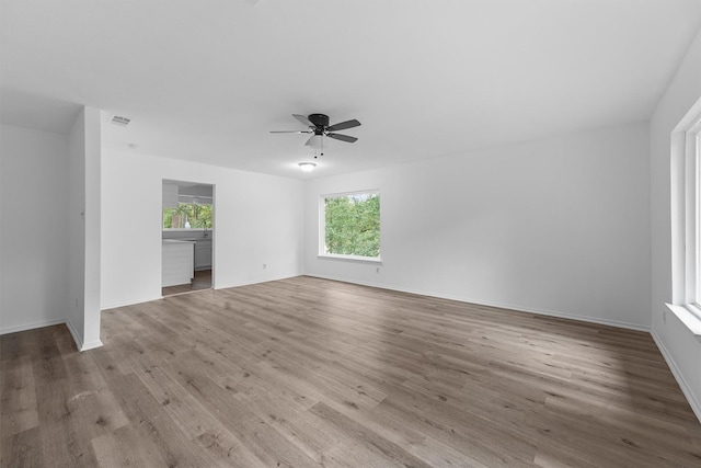 unfurnished living room featuring ceiling fan and light hardwood / wood-style flooring