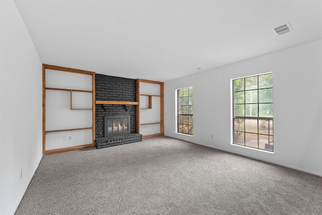 unfurnished living room with carpet and a fireplace