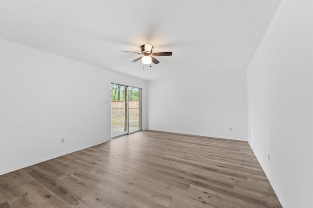 empty room featuring ceiling fan and light hardwood / wood-style floors