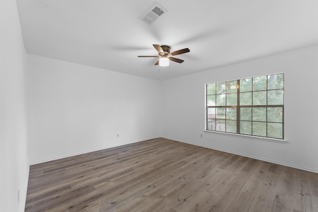 unfurnished room with ceiling fan and hardwood / wood-style floors