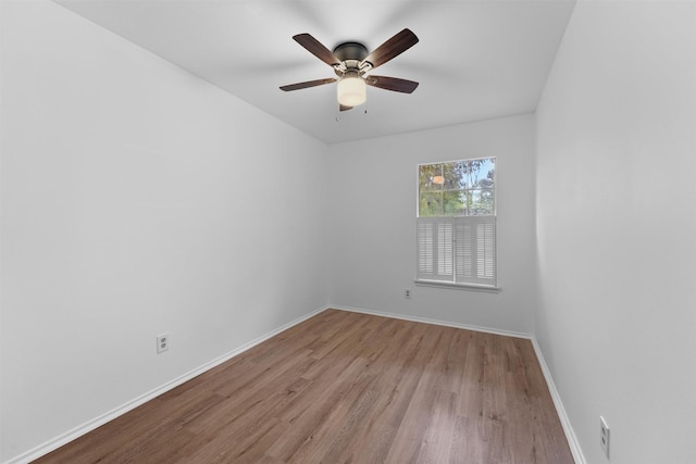 empty room with ceiling fan and light hardwood / wood-style floors